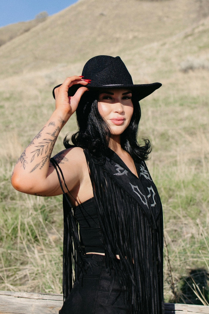 Black western cowboy hat styled for edgy cowgirl outfits, country concert fashion and western festival looks, Nashville outfits from Sand + Charcoal